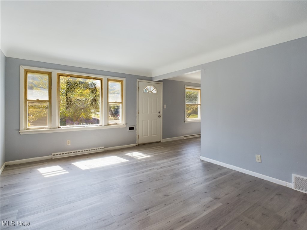 793 Alhambra Road Cleveland, OH 44110 - Photo 7 of 25 Empty room featuring wood-type flooring