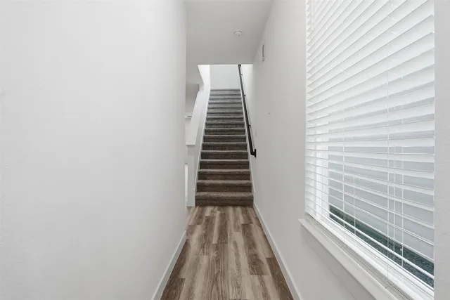 a view of a hallway with stairs