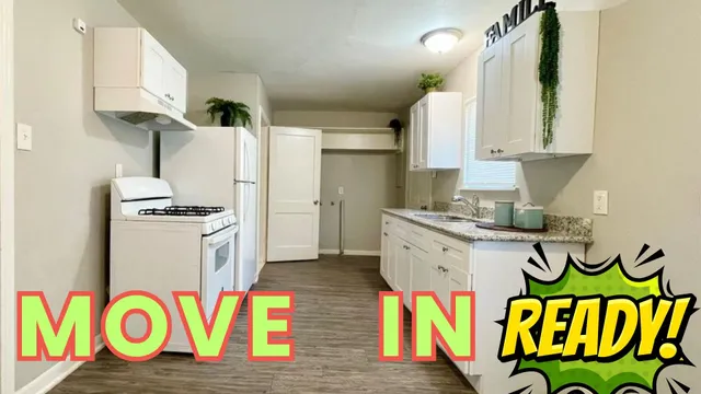 a kitchen with stainless steel appliances granite countertop a refrigerator and a stove