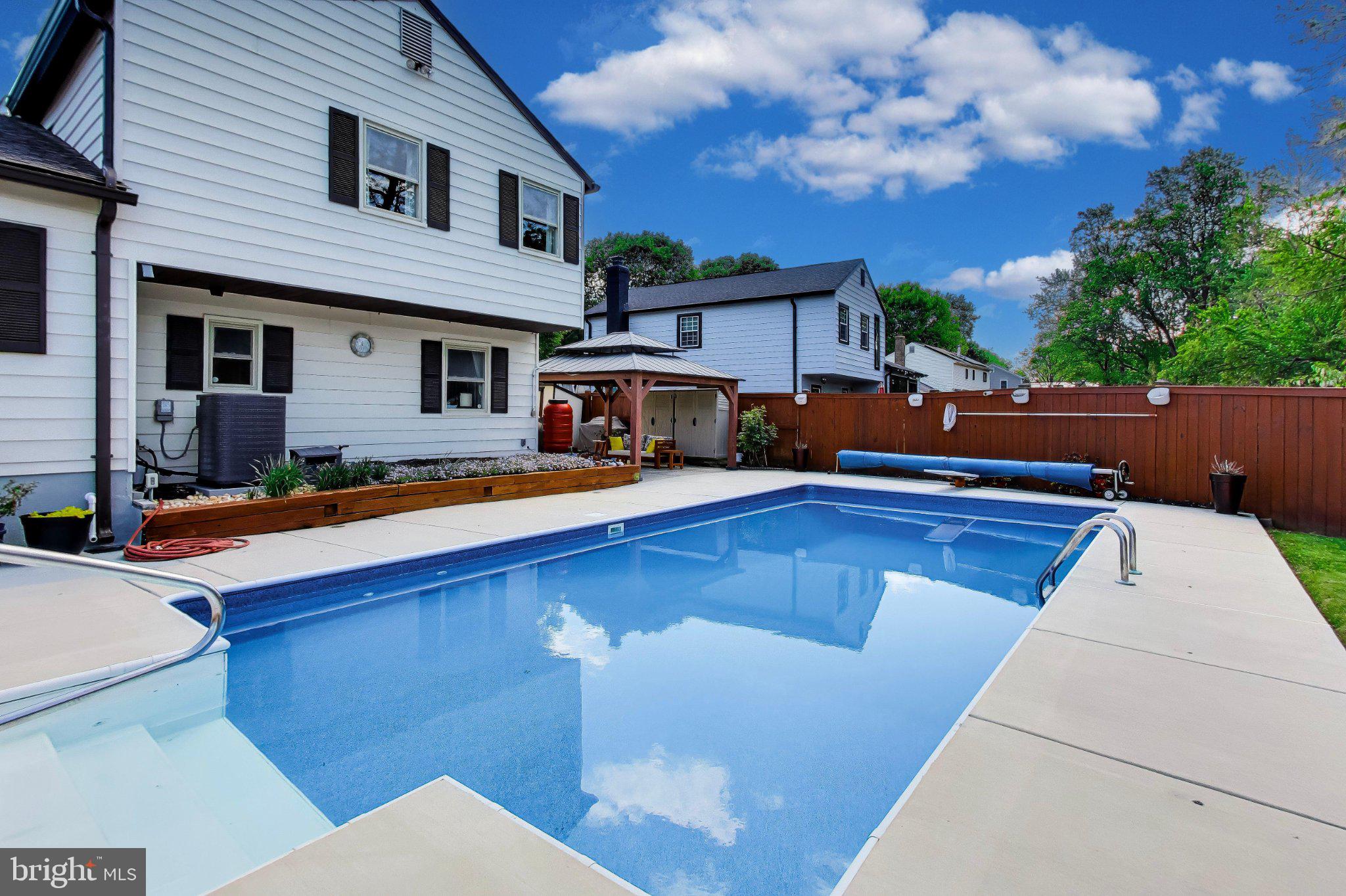 14216 Alderton Road Silver Spring, MD 20906 - Photo 43 of 63 a view of house with outdoor space and swimming pool