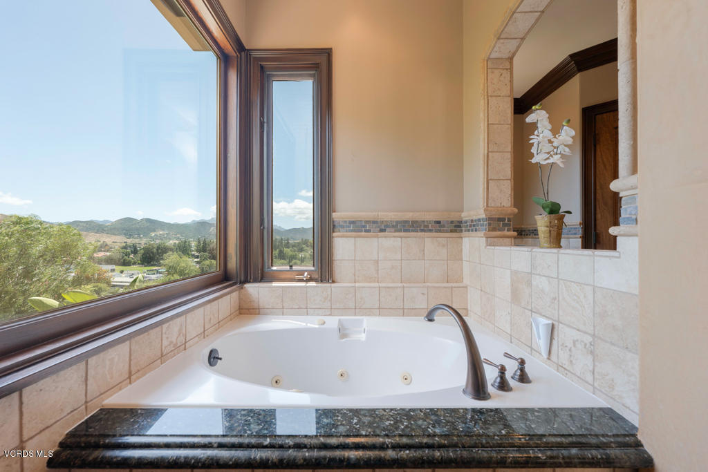 969 Rancho Road Thousand Oaks, CA 91362 - Photo 12 of 54 a bathroom with a bathtub and window