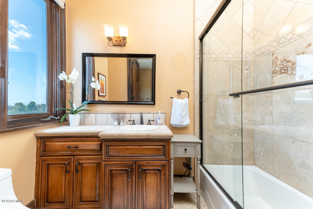 969 Rancho Road Thousand Oaks, CA 91362 - Photo 17 of 54 a bathroom with a sink and a mirror