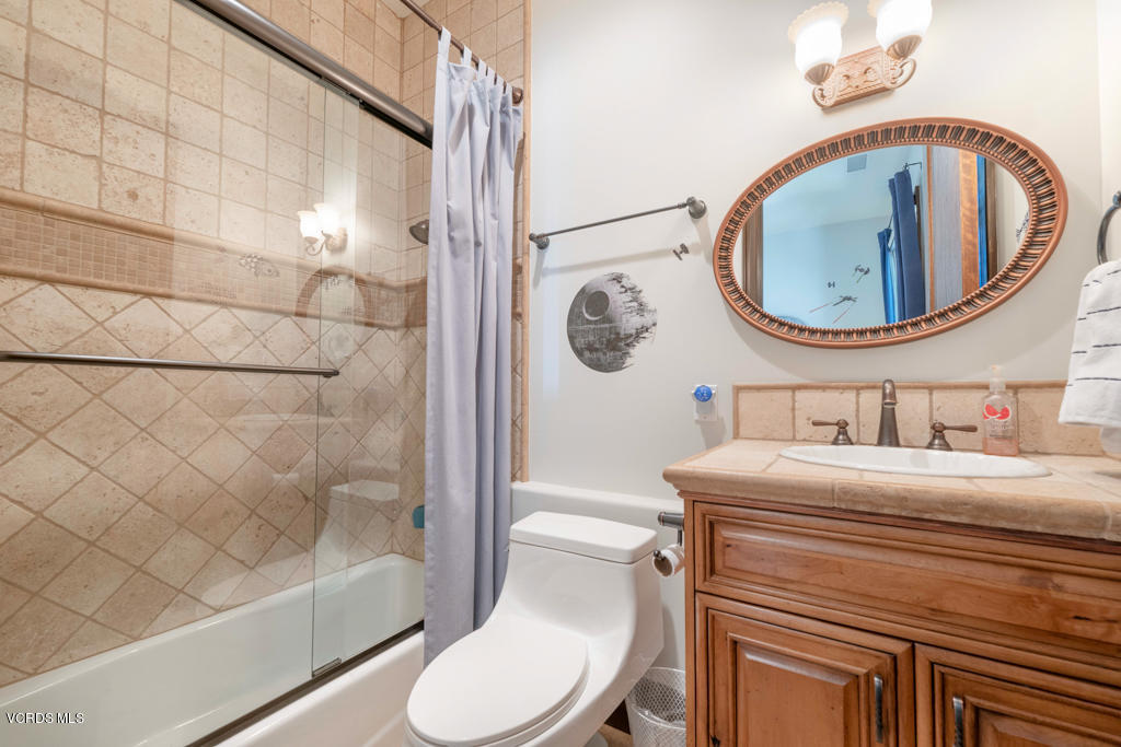 969 Rancho Road Thousand Oaks, CA 91362 - Photo 19 of 54 a bathroom with a toilet a sink and a mirror