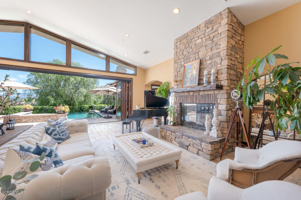 969 Rancho Road Thousand Oaks, CA 91362 - Photo 4 of 54 a living room with furniture a fireplace and a large window