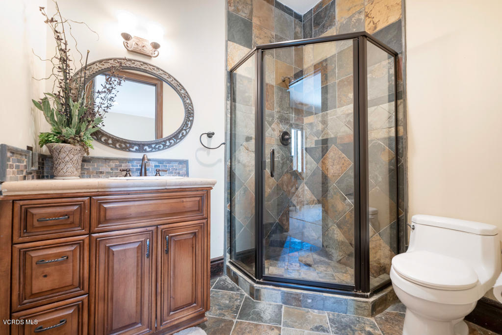969 Rancho Road Thousand Oaks, CA 91362 - Photo 33 of 54 a bathroom with a toilet a sink and a mirror