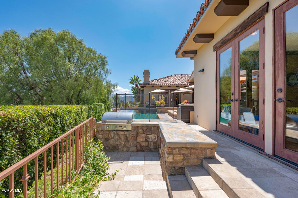 969 Rancho Road Thousand Oaks, CA 91362 - Photo 39 of 54 a view of a patio with table and chairs with wooden floor and fence