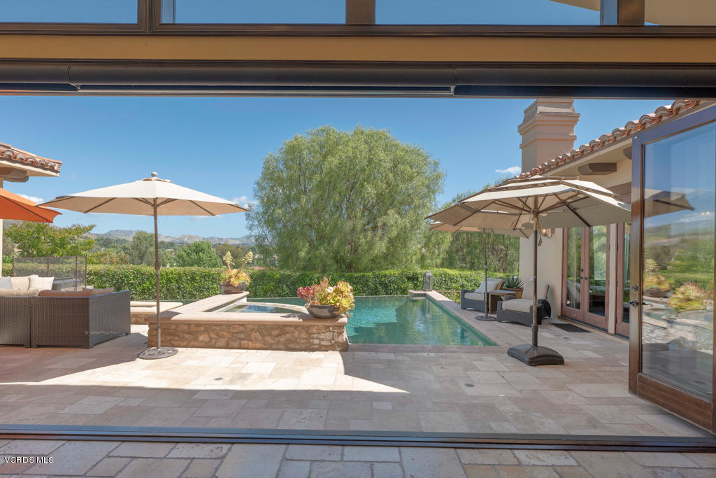 969 Rancho Road Thousand Oaks, CA 91362 - Photo 6 of 54 a patio with a table and chairs under an umbrella