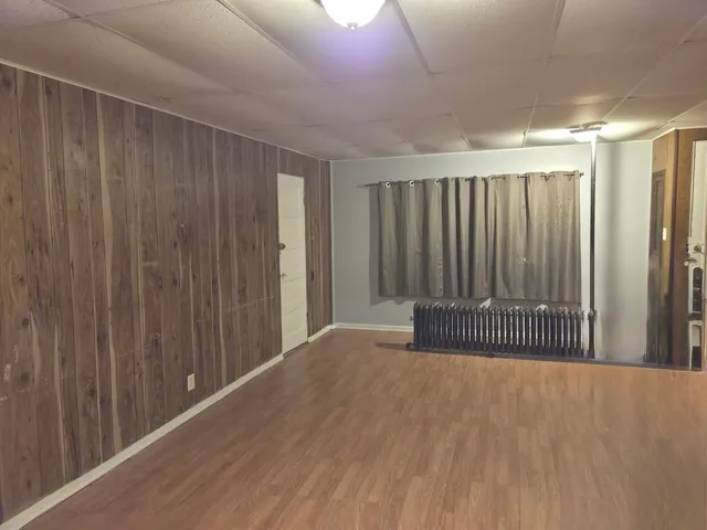 a view of a room with wooden floor