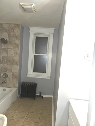 a bathroom with a bathtub and a sink