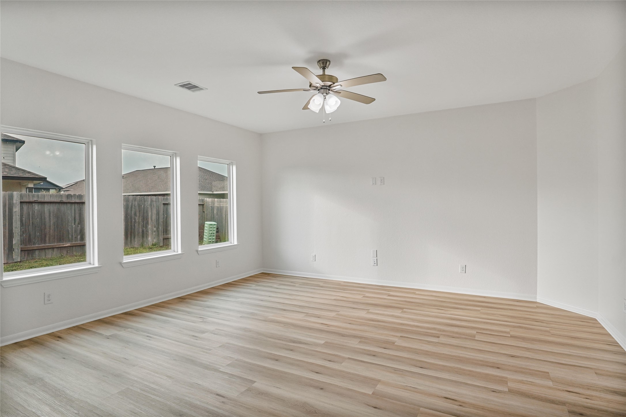 10511 Kings River Drive Rosharon, TX 77583 - Photo 4 of 25 a view of an empty room with a window and wooden floor