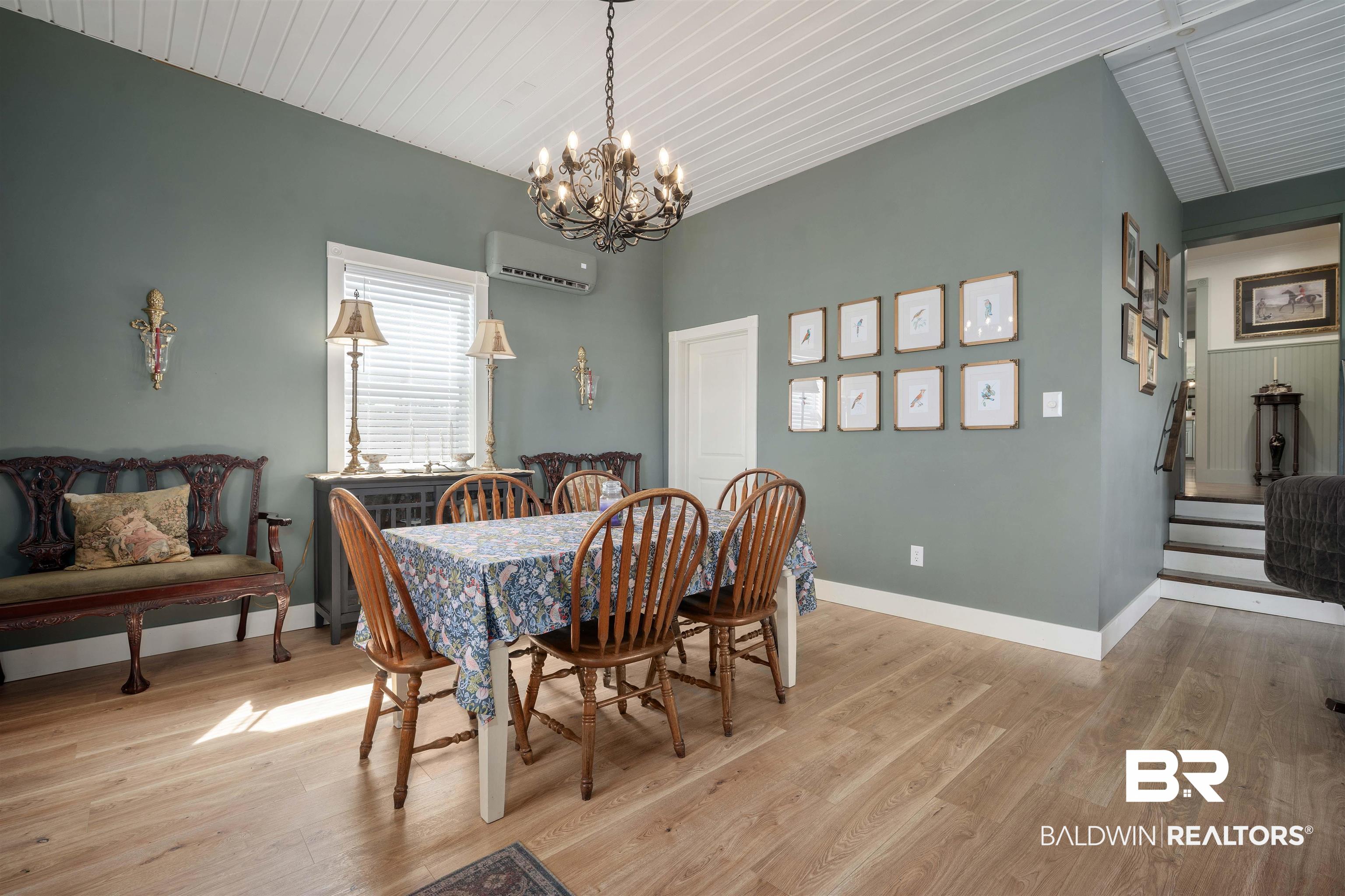 22 Horace Odom Road Millry, AL 36558 - Photo 16 of 39 Dining space featuring light wood-style floors, a chandelier, and a wall mounted mini split