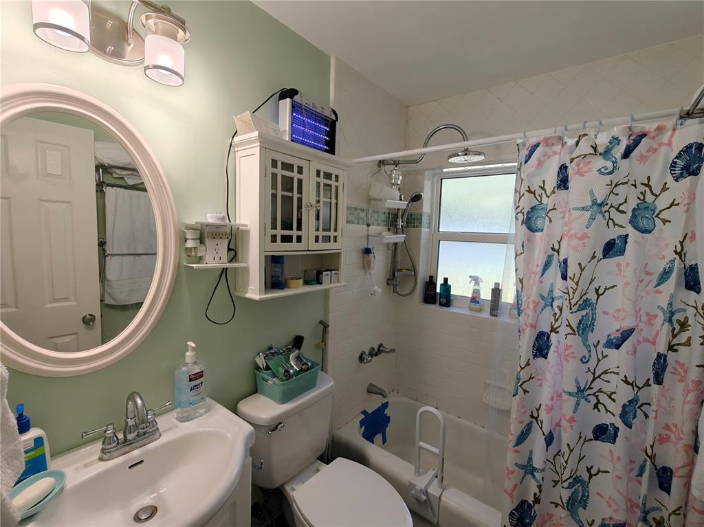 2305 Northwest 48th Terrace Gainesville, FL 32606 - Photo 11 of 20 a bathroom with a sink mirror toilet and shower