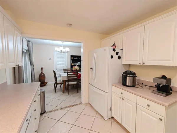 a kitchen with cabinets and chairs in it