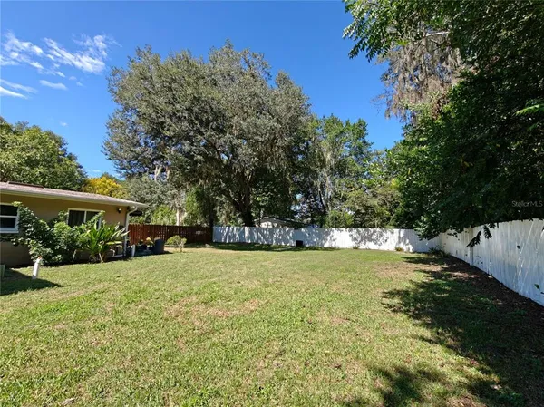 a view of a yard with a house in the background