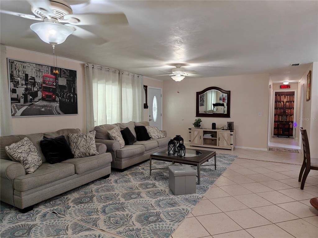 2305 Northwest 48th Terrace Gainesville, FL 32606 - Photo 5 of 20 a living room with furniture and wooden floor