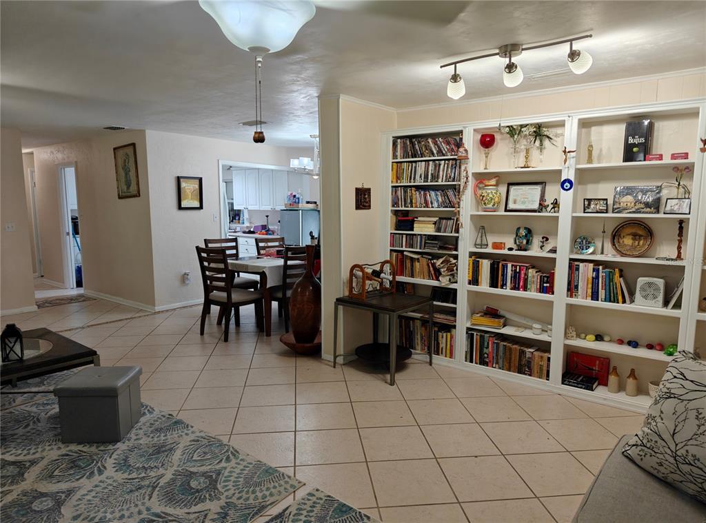 2305 Northwest 48th Terrace Gainesville, FL 32606 - Photo 6 of 20 a living room with furniture a book shelf and a window