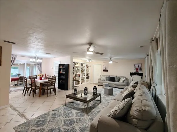 a living room with furniture and kitchen view