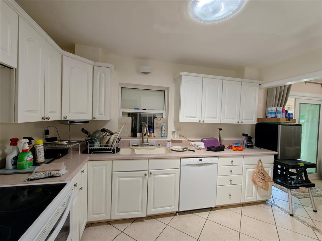 2305 Northwest 48th Terrace Gainesville, FL 32606 - Photo 8 of 20 a kitchen with sink a stove and cabinets