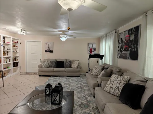 a living room with furniture and a chandelier