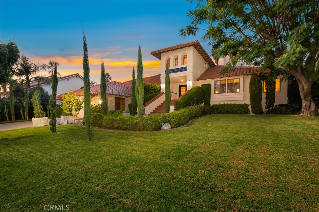 10652 Ridge Canyon Road Rancho Cucamonga, CA 91737 - Photo 1 of 1 a view of a house with a big yard and palm trees
