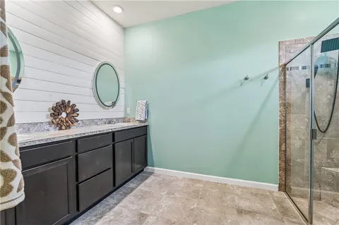 a bathroom with a shower and a glass door