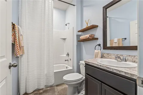 an empty room with a window and ceiling fan