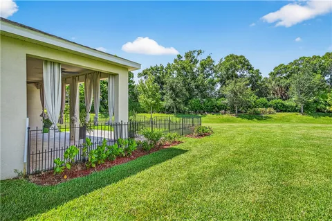 an aerial view of a house with a garden and swimming pool