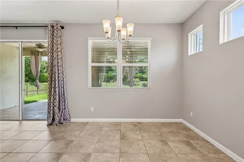 a view of kitchen with granite countertop stove top oven and cabinets