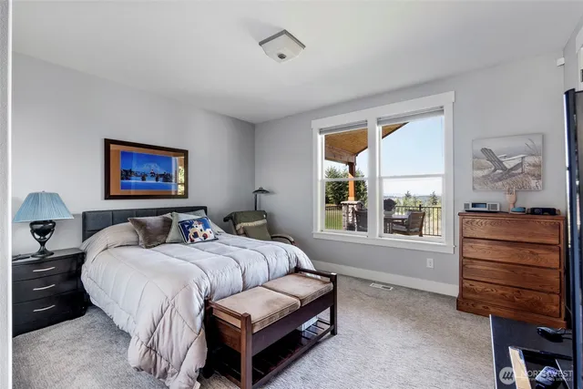 a bedroom with a bed a desk and chair