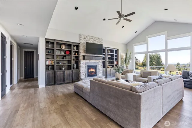 a living room with furniture a large window and a flat screen tv