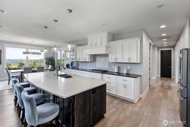 a kitchen with a sink stove and cabinets