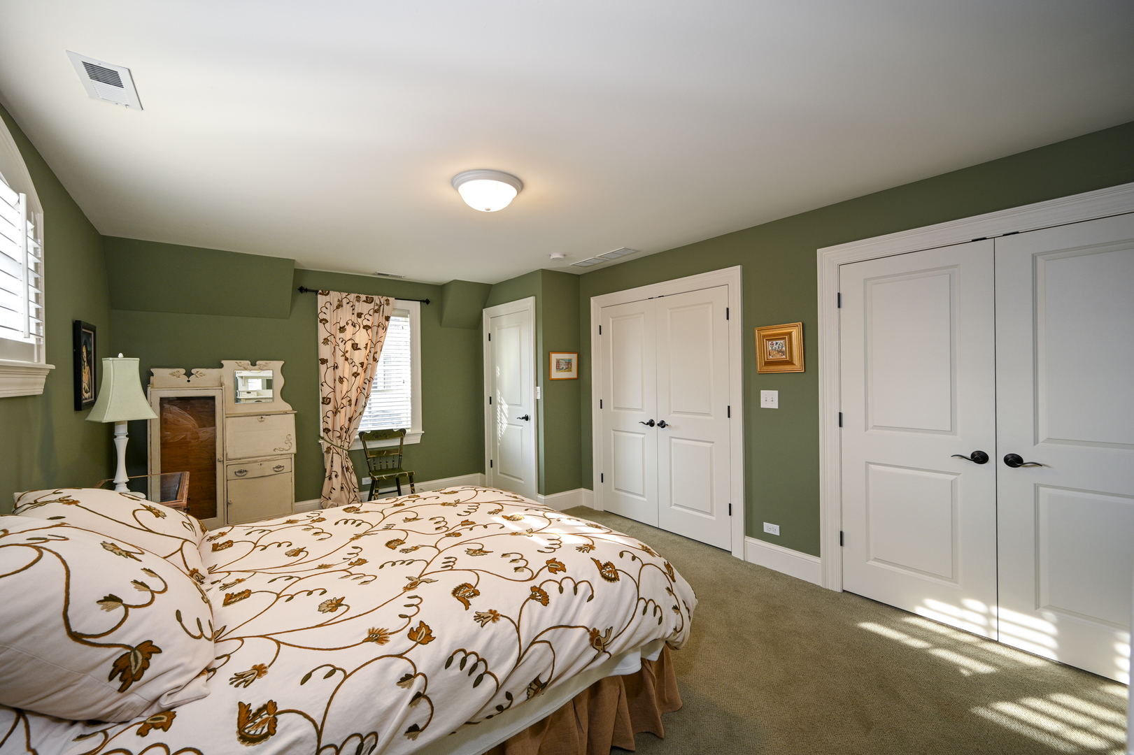 Undisclosed Address Glen Ellyn, IL 60137 - Photo 35 of 45 a bedroom with a large bed and a chandelier