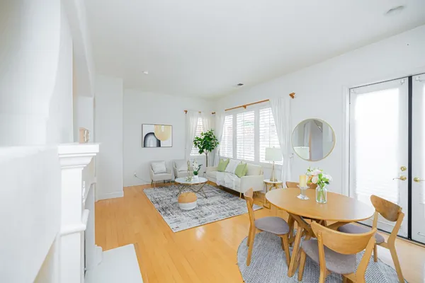 a living room with furniture a table and a painting on the wall