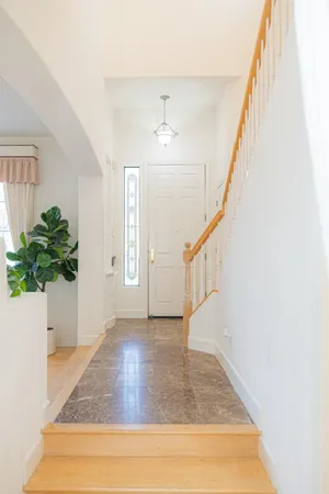 a view of entryway and hall with wooden floor