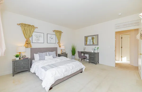 a bedroom with a bed a table and chair