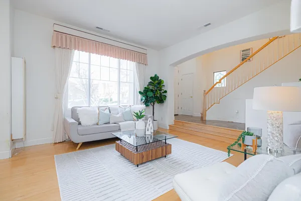 a living room with furniture and wooden floor