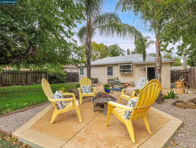 a view of a house with swimming pool and sitting area