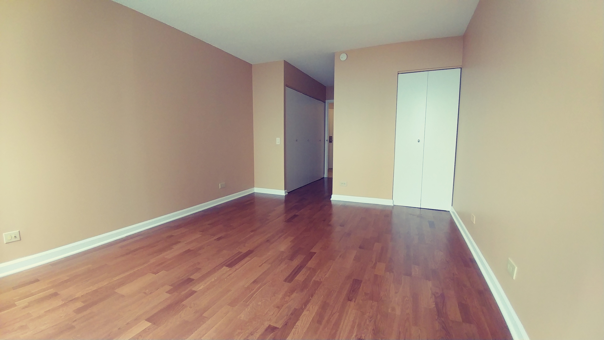5320 North Sheridan Road, Unit 1207 Chicago, IL 60640 - Photo 13 of 20 an empty room with wooden floor