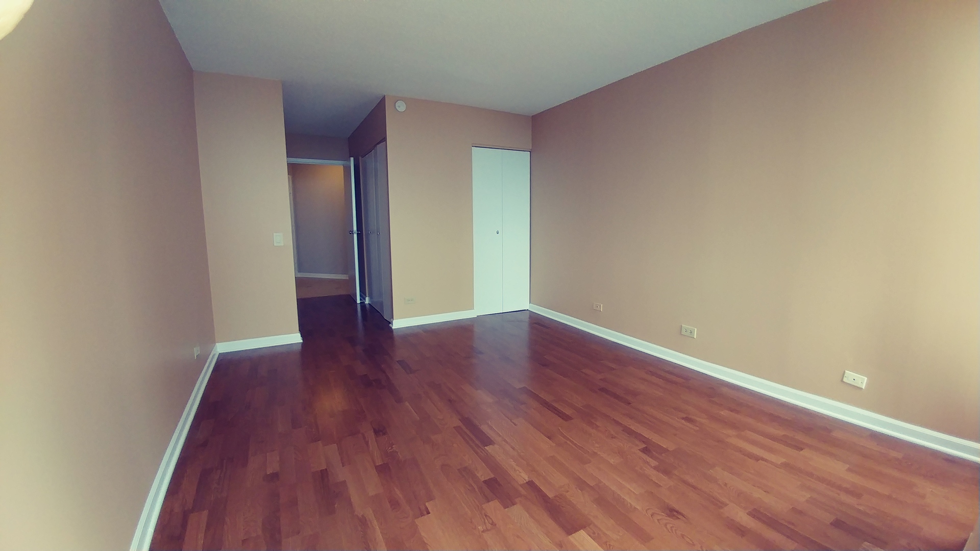 5320 North Sheridan Road, Unit 1207 Chicago, IL 60640 - Photo 14 of 20 a view of an empty room with wooden floor
