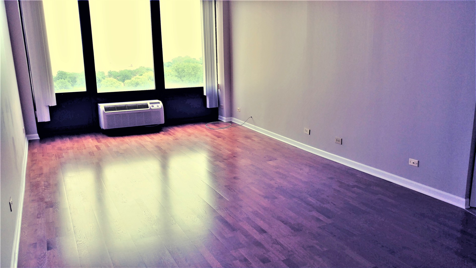5320 North Sheridan Road, Unit 1207 Chicago, IL 60640 - Photo 10 of 20 a view of an empty room and wooden floor