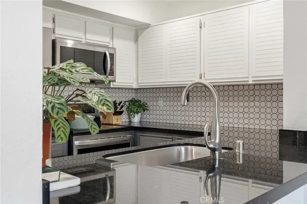 a potted plant sitting on top of a kitchen counter