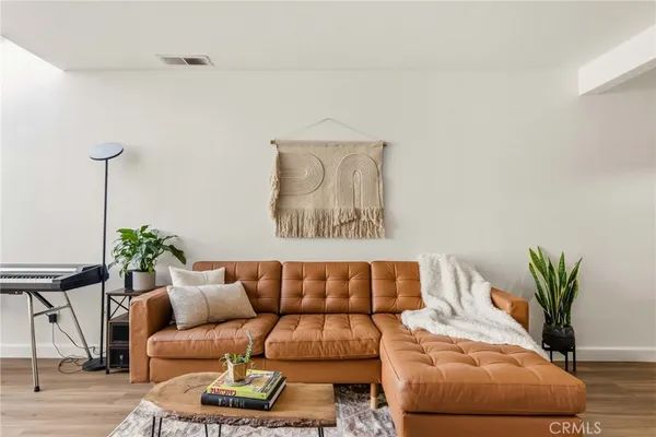 a living room with furniture and a potted plant