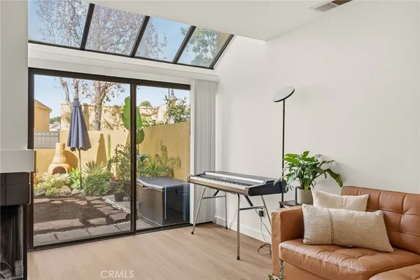 a living room with furniture and a potted plant