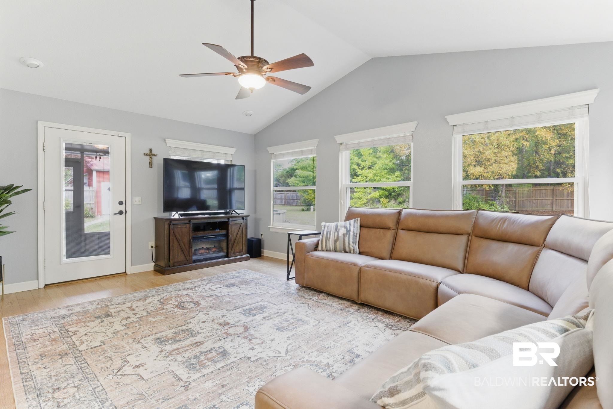 32345 River Lake Road Seminole, AL 36574 - Photo 7 of 56 Living room featuring wood finished floors, a ceiling fan, lofted ceiling, and a wealth of natural light