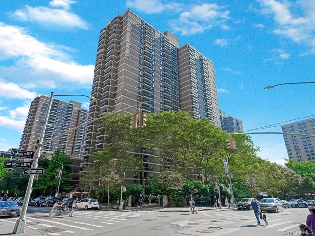 a view of a tall building next to a road