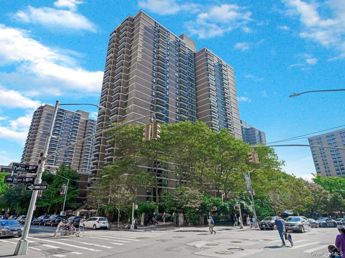 a view of a tall building next to a road