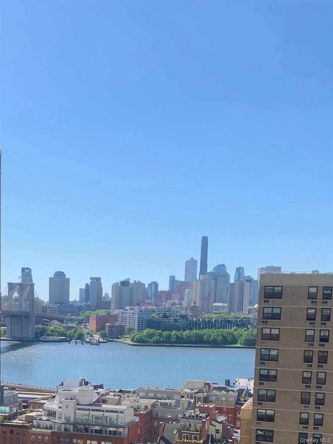 77 Fulton Street, Unit 19C Manhattan, NY 10038 - Photo 15 of 20 a view of a city with tall buildings in the background