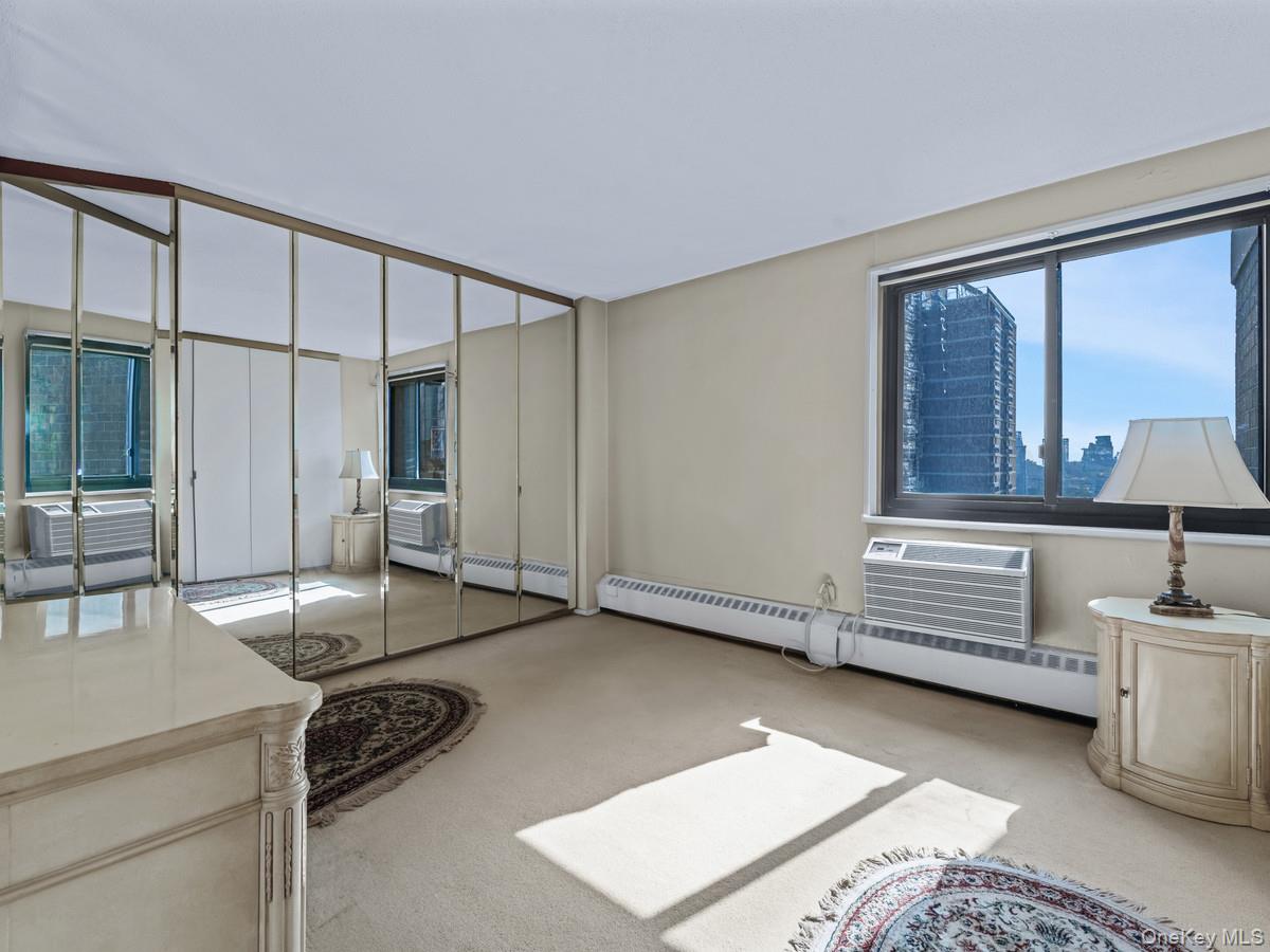 77 Fulton Street, Unit 19C Manhattan, NY 10038 - Photo 16 of 20 a view of a livingroom with furniture and windows