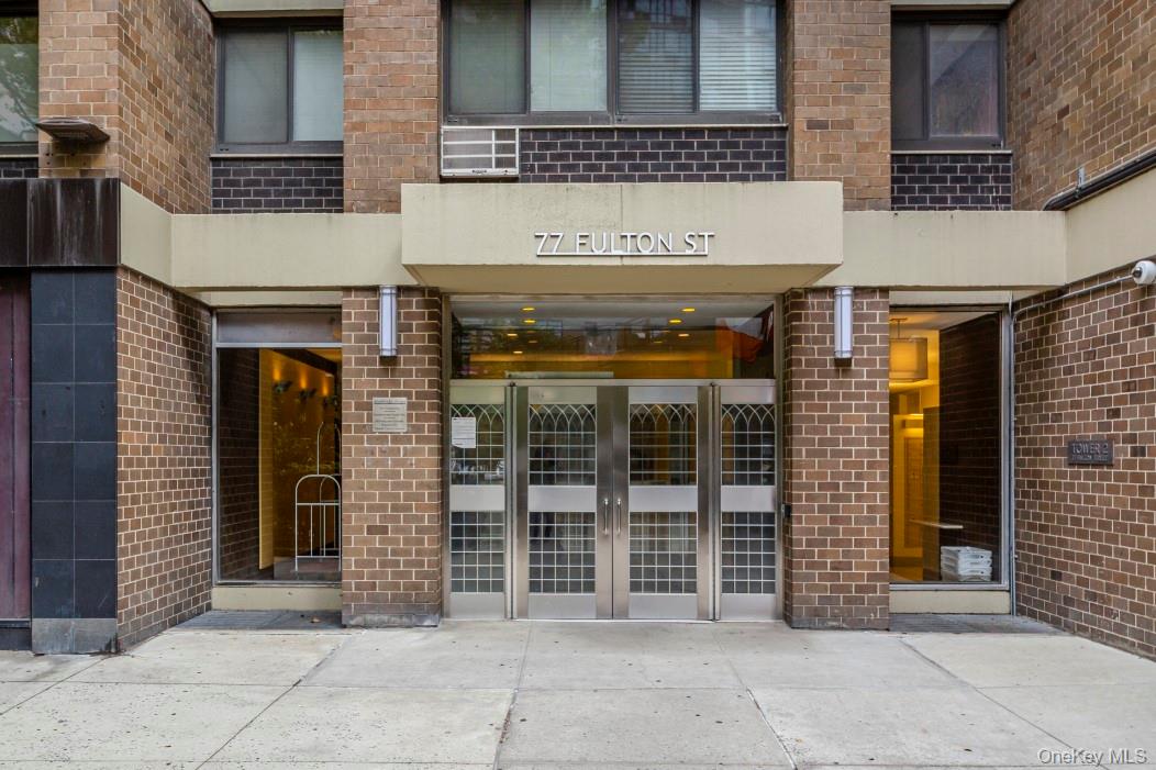 77 Fulton Street, Unit 19C Manhattan, NY 10038 - Photo 2 of 20 a view of a brick building with a entrance door