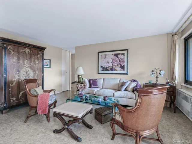 a living room with furniture a rug and a large window